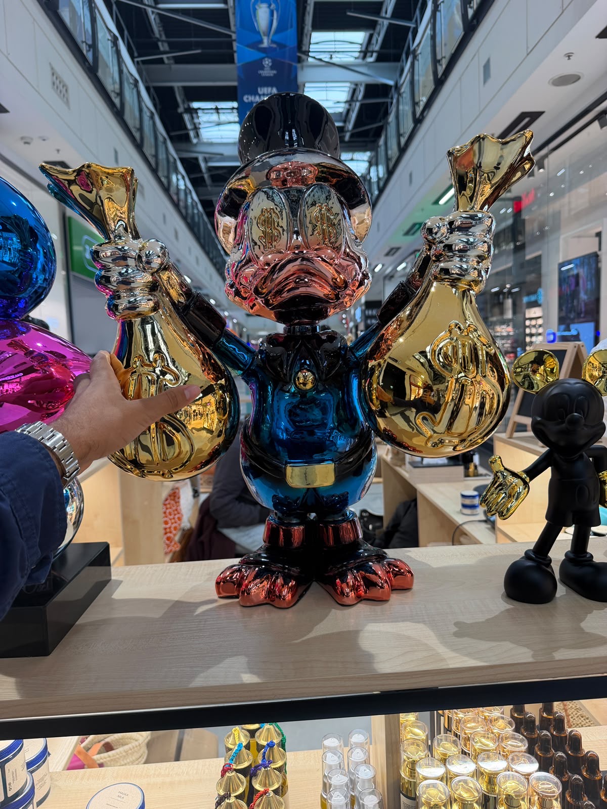 Chrome duck with gold money bags